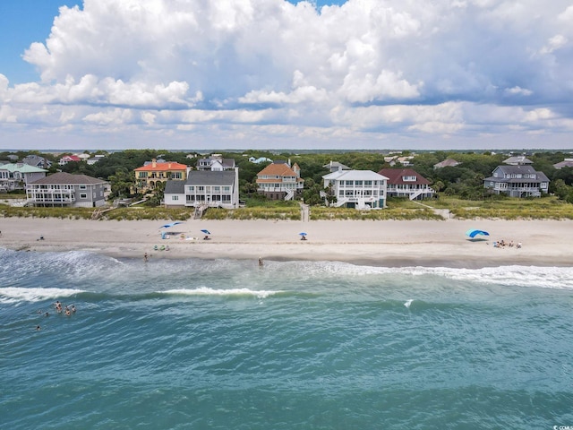 drone / aerial view with a water view and a view of the beach