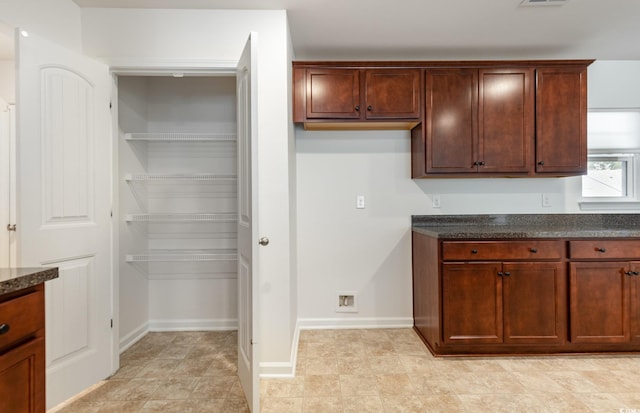 357 Cardita Loop, Myrtle Beach, SC 29588 - kitchen with dark stone countertops and baseboards