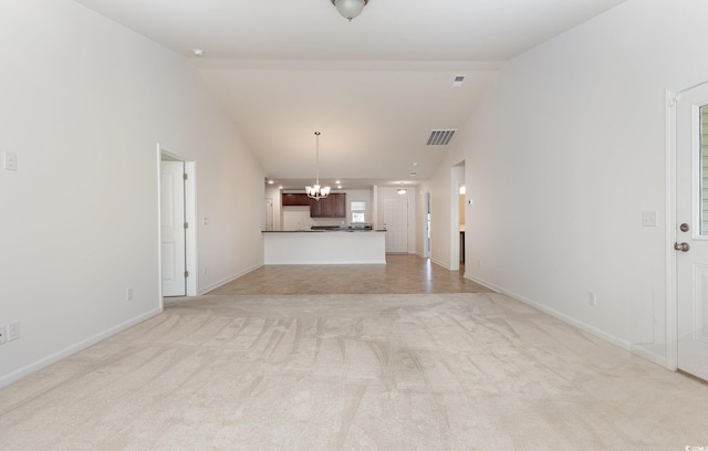 unfurnished living room with lofted ceiling, light carpet, and an inviting chandelier