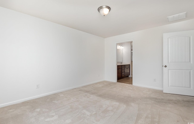 empty room with light colored carpet