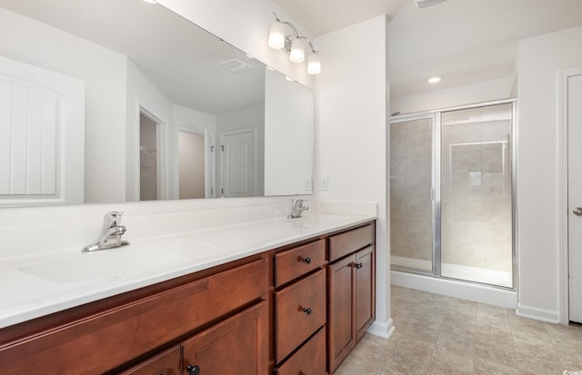 bathroom featuring vanity and a shower with shower door