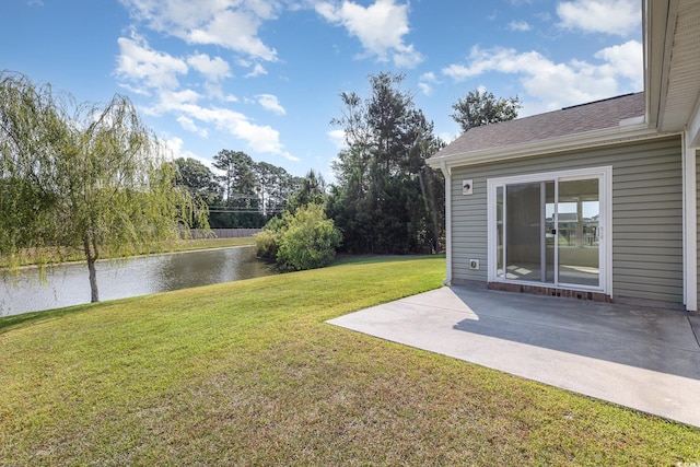 view of yard featuring a water view and a patio area