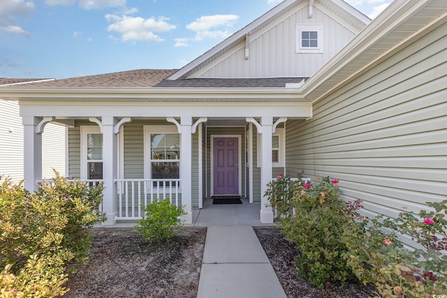 view of exterior entry with covered porch