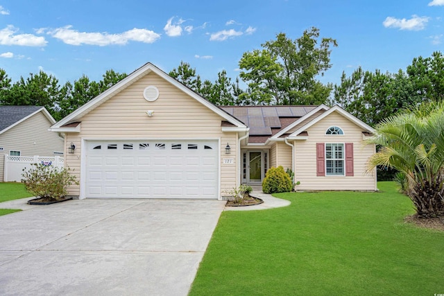 ranch-style home with a front yard, solar panels, and a garage