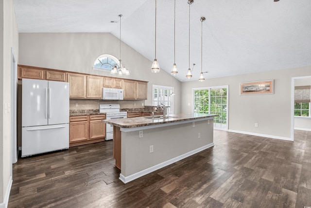 kitchen featuring backsplash, a breakfast bar, white appliances, sink, and hanging light fixtures