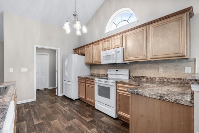 kitchen featuring hanging light fixtures, high vaulted ceiling, dark hardwood / wood-style floors, a chandelier, and white appliances