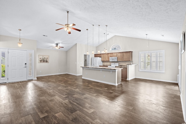 unfurnished living room with ceiling fan, dark hardwood / wood-style flooring, high vaulted ceiling, and a textured ceiling