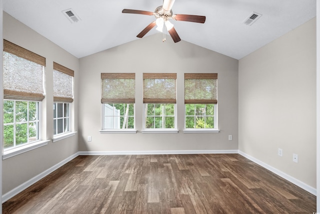 spare room featuring dark hardwood / wood-style flooring, vaulted ceiling, and ceiling fan