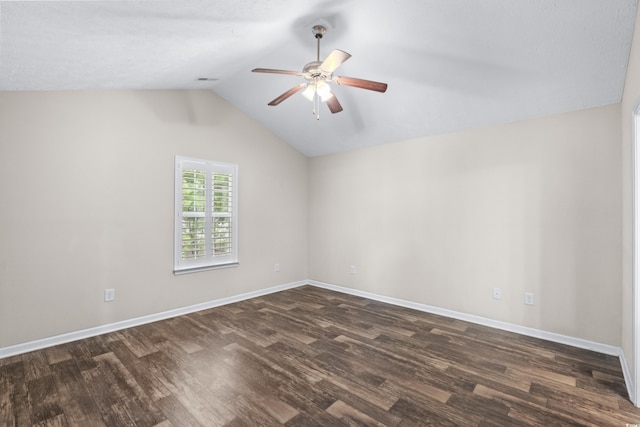 empty room with dark hardwood / wood-style floors, vaulted ceiling, and ceiling fan