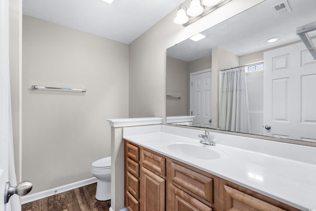 bathroom with hardwood / wood-style flooring, vanity, toilet, and a shower with shower curtain