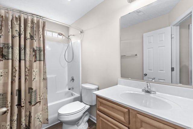 full bathroom featuring shower / bath combo with shower curtain, vanity, and toilet