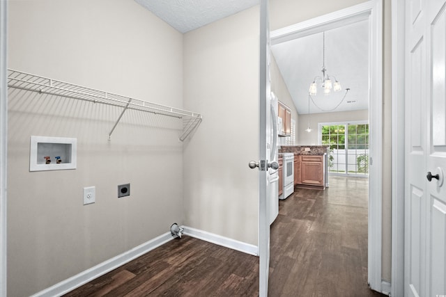 clothes washing area with hookup for an electric dryer, washer hookup, a chandelier, and dark wood-type flooring