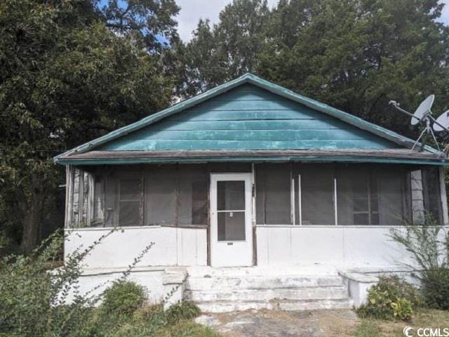 view of front of property featuring a sunroom