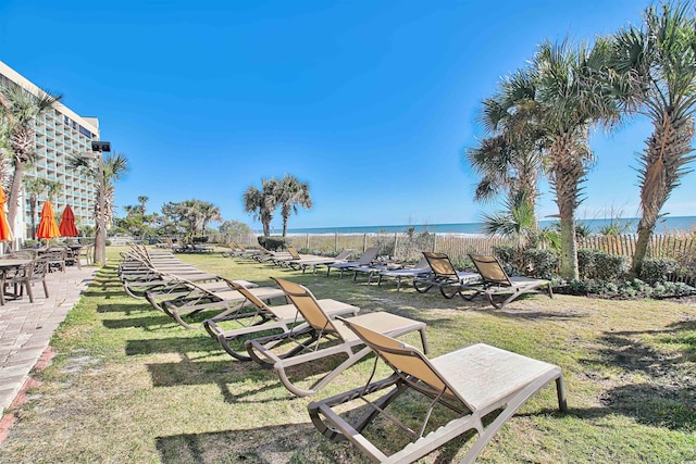 surrounding community featuring a water view and a lawn