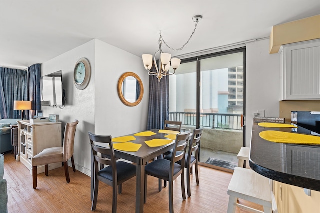 dining space featuring an inviting chandelier and light hardwood / wood-style floors