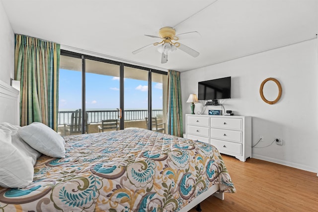 bedroom with ceiling fan, access to outside, light hardwood / wood-style flooring, and floor to ceiling windows