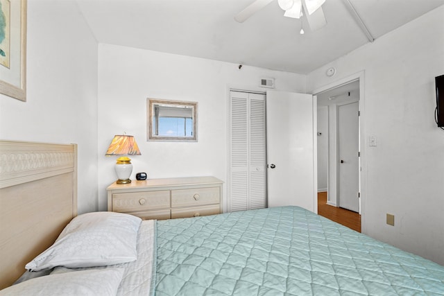 bedroom with ceiling fan, hardwood / wood-style flooring, and a closet