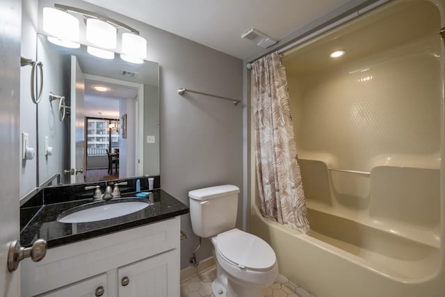 full bathroom featuring shower / bath combo with shower curtain, tile patterned floors, toilet, and vanity