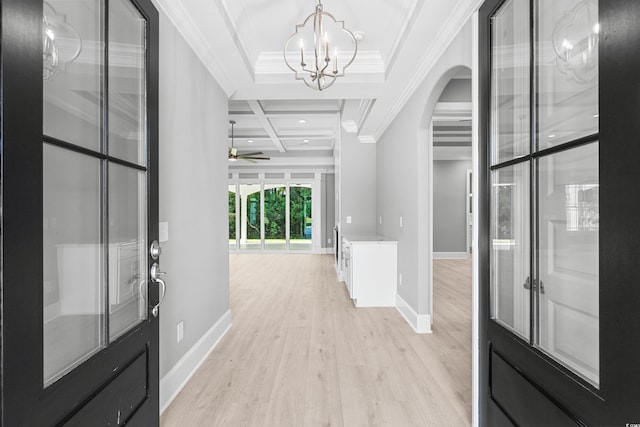 entryway featuring beamed ceiling, coffered ceiling, ornamental molding, light hardwood / wood-style flooring, and ceiling fan with notable chandelier