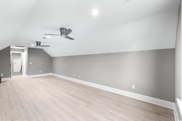 additional living space featuring light hardwood / wood-style flooring, vaulted ceiling, and ceiling fan