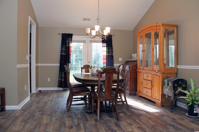 dining room featuring dark hardwood / wood-style flooring, lofted ceiling, and a chandelier