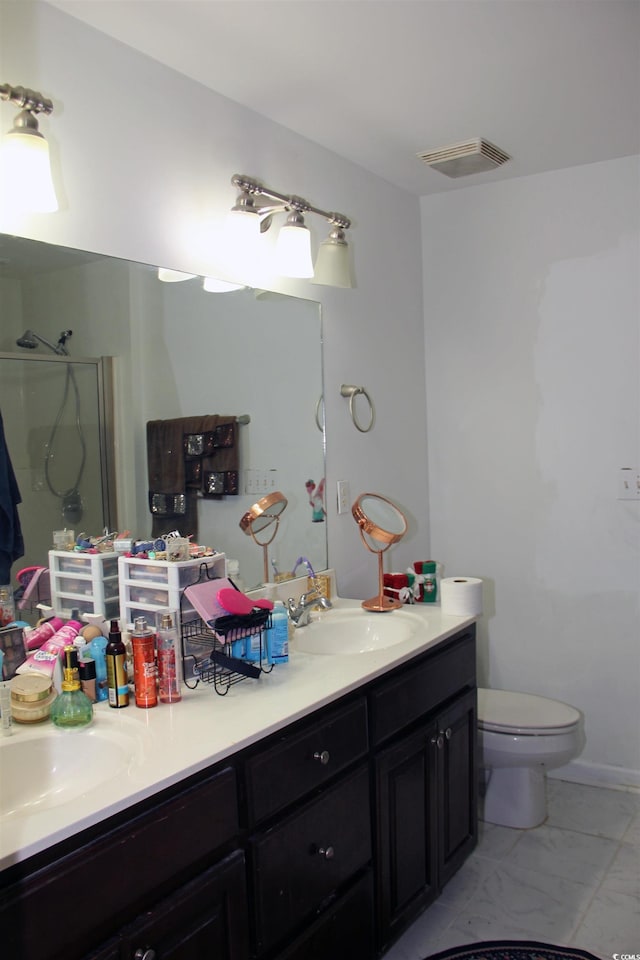 bathroom with vanity, a shower with shower door, and toilet