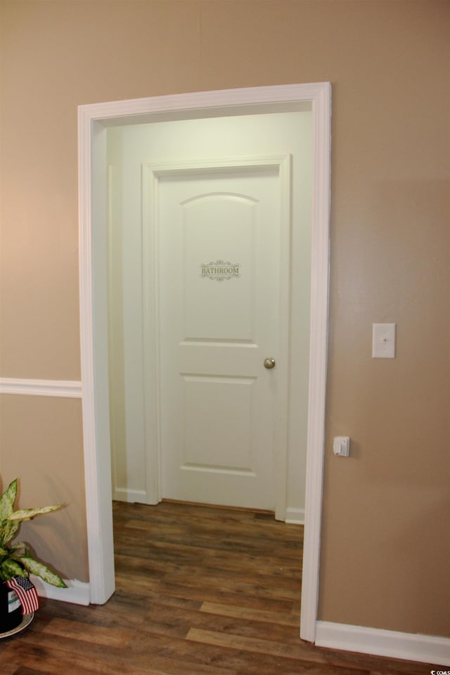 hallway with dark wood-type flooring