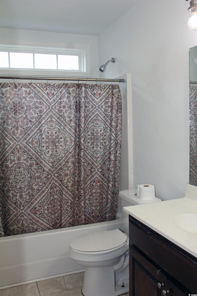 full bathroom featuring tile patterned flooring, vanity, shower / bath combo with shower curtain, and toilet