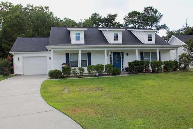 view of front of property featuring a garage, a front lawn, and covered porch