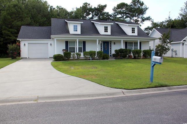 view of front of home featuring a garage, covered porch, and a front yard