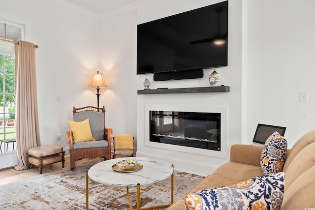 living room featuring ornamental molding, a healthy amount of sunlight, and hardwood / wood-style floors