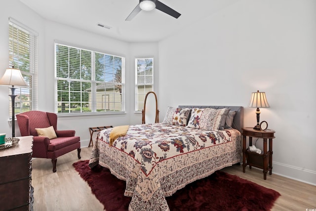 bedroom with light hardwood / wood-style flooring and ceiling fan