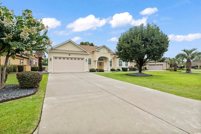 ranch-style house featuring a garage and a front yard