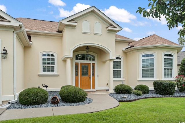 property entrance with a yard