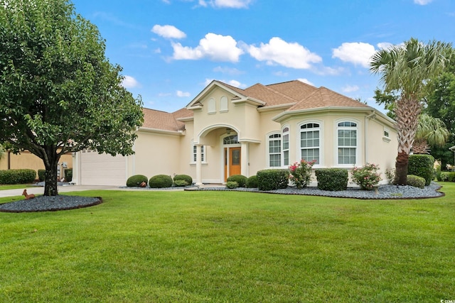 mediterranean / spanish house featuring a front lawn