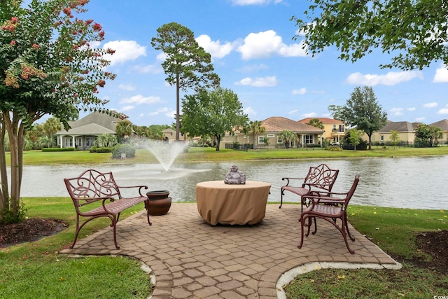 view of property's community with a water view and a yard