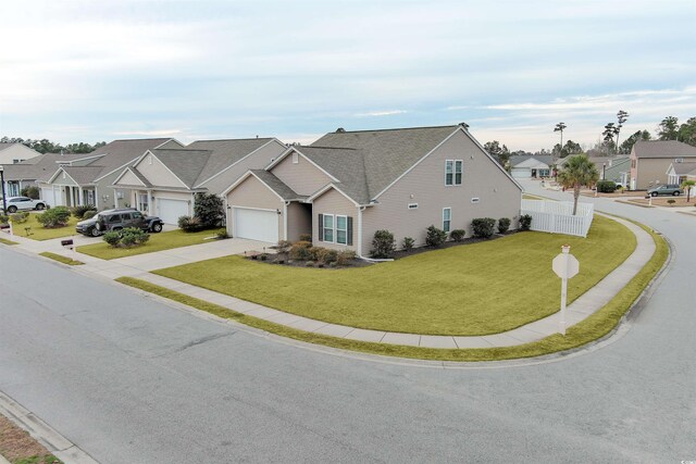 view of front of home with a front lawn and a garage