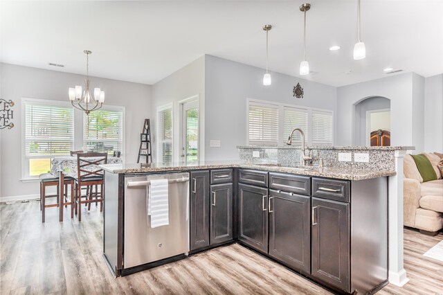 kitchen featuring sink, dishwasher, light hardwood / wood-style floors, hanging light fixtures, and dark brown cabinets