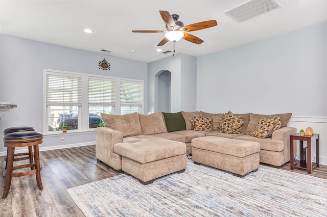 living room with hardwood / wood-style floors and ceiling fan