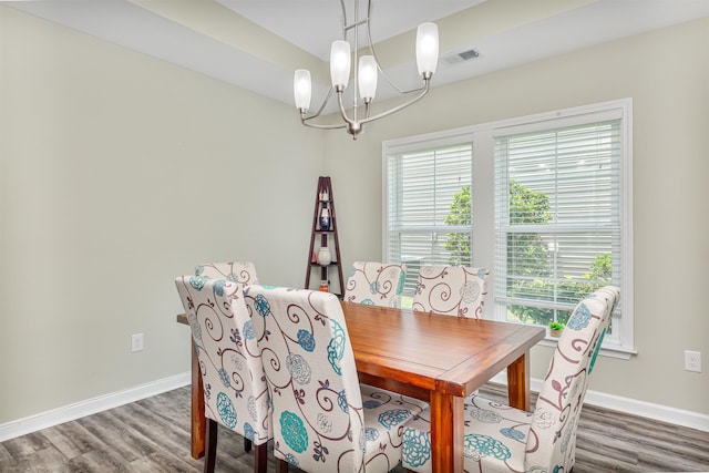 dining room featuring hardwood / wood-style flooring and a notable chandelier