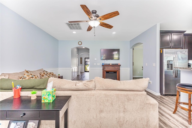 living room with light wood-type flooring and ceiling fan