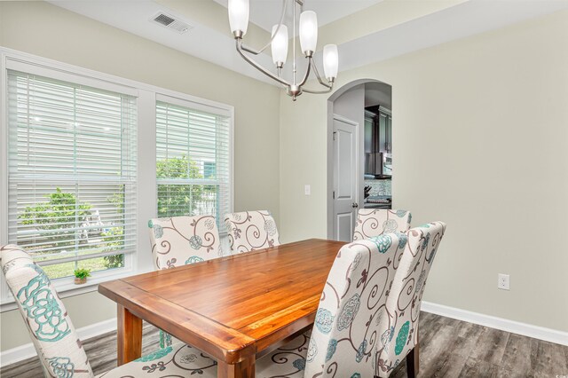 dining space featuring a chandelier and wood-type flooring