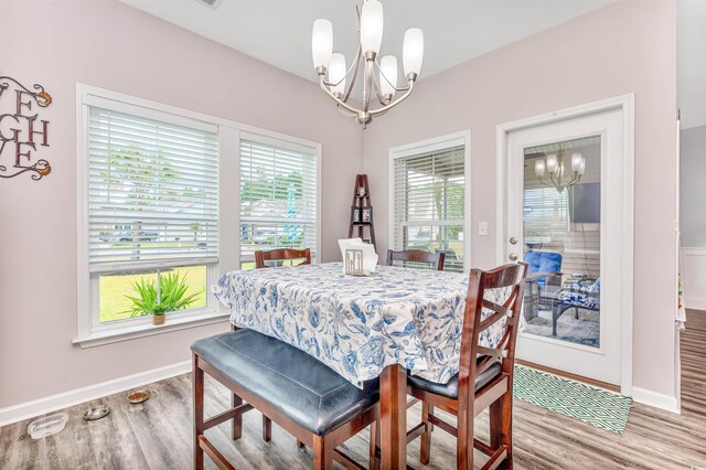 dining room featuring light hardwood / wood-style flooring and a notable chandelier