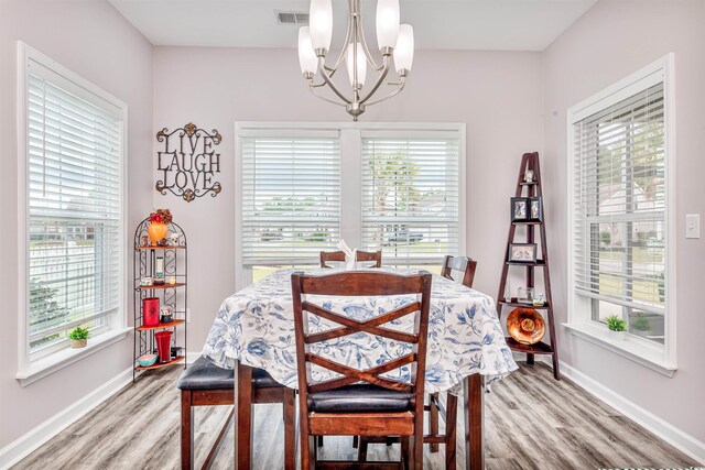 dining area featuring a chandelier and light hardwood / wood-style flooring