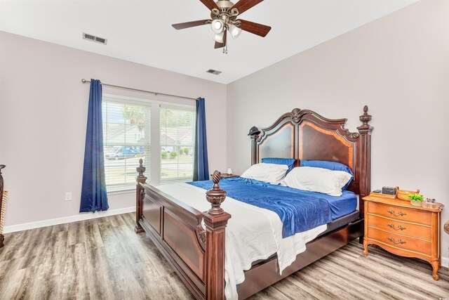 bedroom with ceiling fan and wood-type flooring