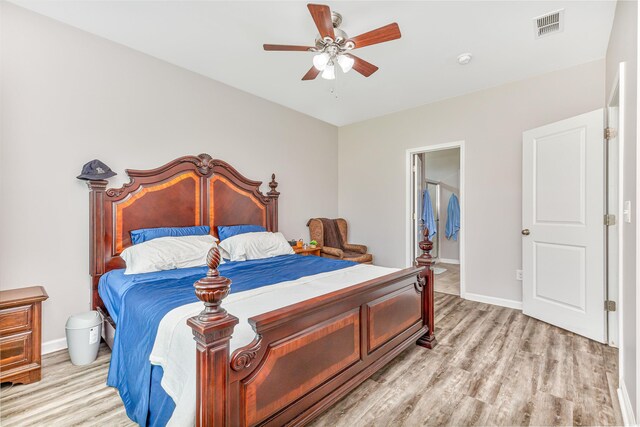 bedroom featuring ceiling fan, ensuite bathroom, and light hardwood / wood-style floors