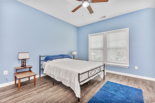 bedroom with ceiling fan and wood-type flooring