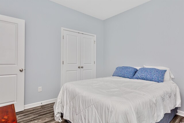 bedroom featuring a closet and dark hardwood / wood-style floors