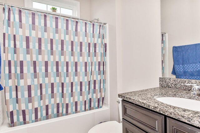 full bathroom featuring shower / bath combination with curtain, toilet, and vanity