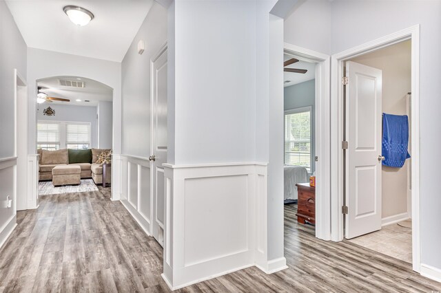 sunroom with ceiling fan and vaulted ceiling